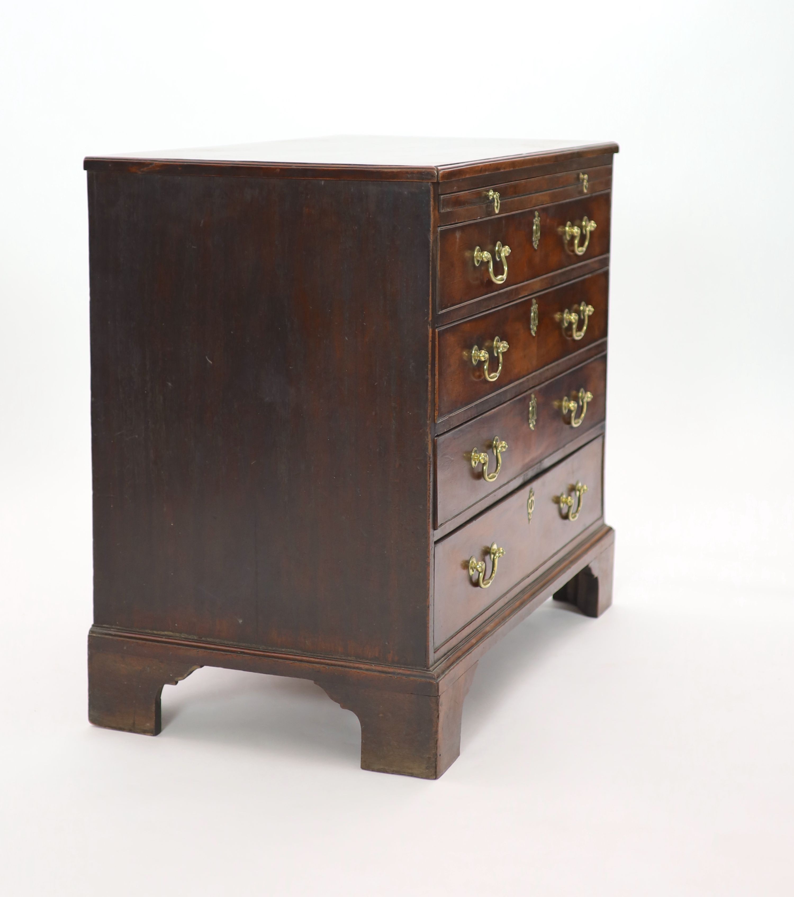 A George III mahogany chest of four graduated long drawers with brushing slide W 93cm D 52cm. H 83cm.